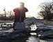 Picture of a girl with a shovel and water flowing down a street gutter, with an Ice bridge, Nice spring pic.

Possibly a picture of the day!		 